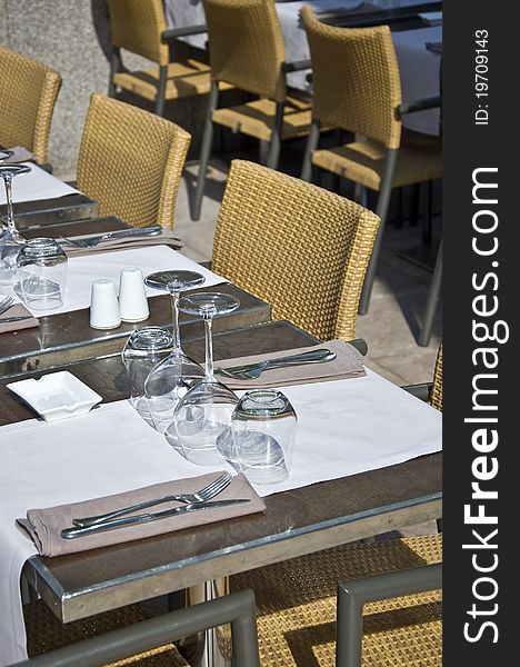 Covered table in the restaurant. Utensils for eating. Urban scene