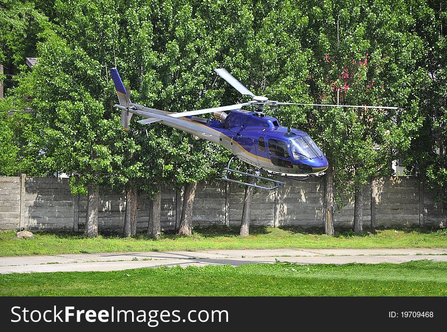 Helicopter departing from the field. Helicopter departing from the field