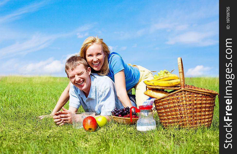 Happy young couple having a picnic outdoor on a summer day. Happy young couple having a picnic outdoor on a summer day