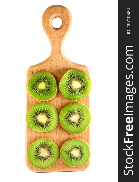 Slices of kiwi on the vertical cutting board isolated over white. Slices of kiwi on the vertical cutting board isolated over white