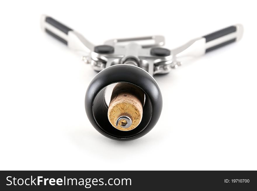 Corkscrew with cork from wine isolated close up