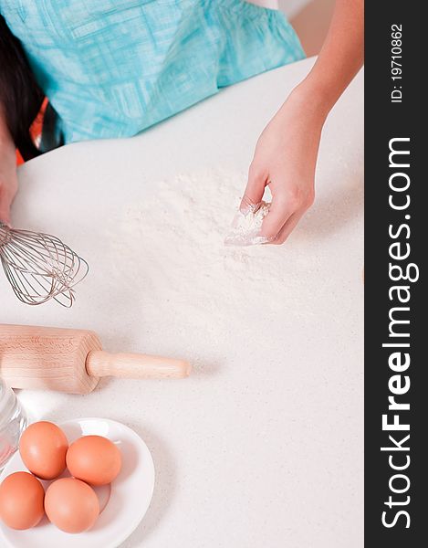 Picture of woman hands mixing flour on the table