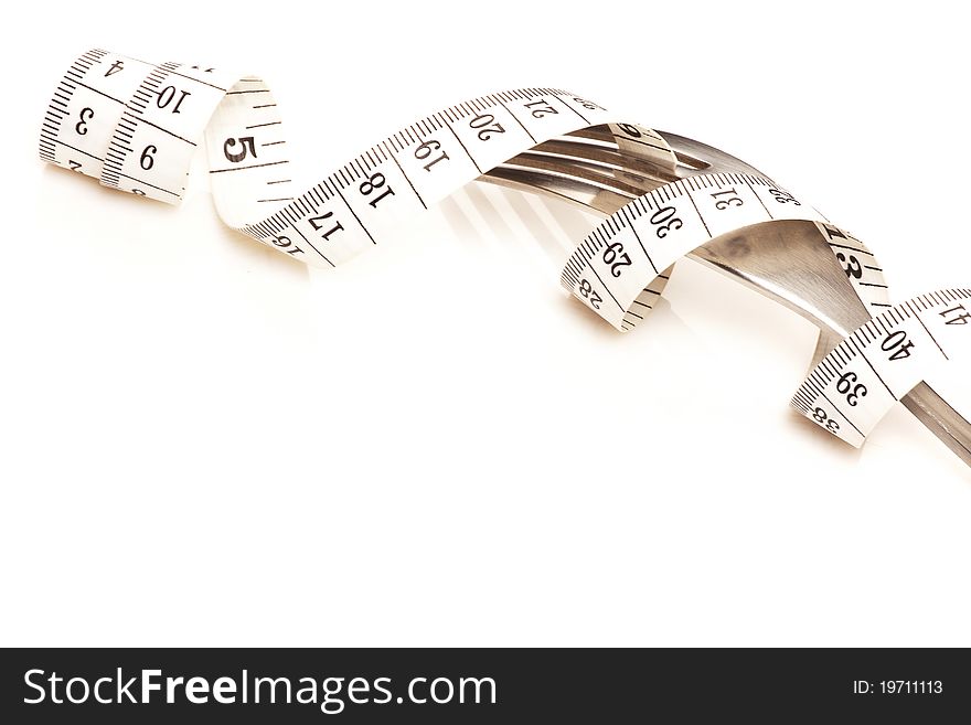 Fork and measure tape isolated over white