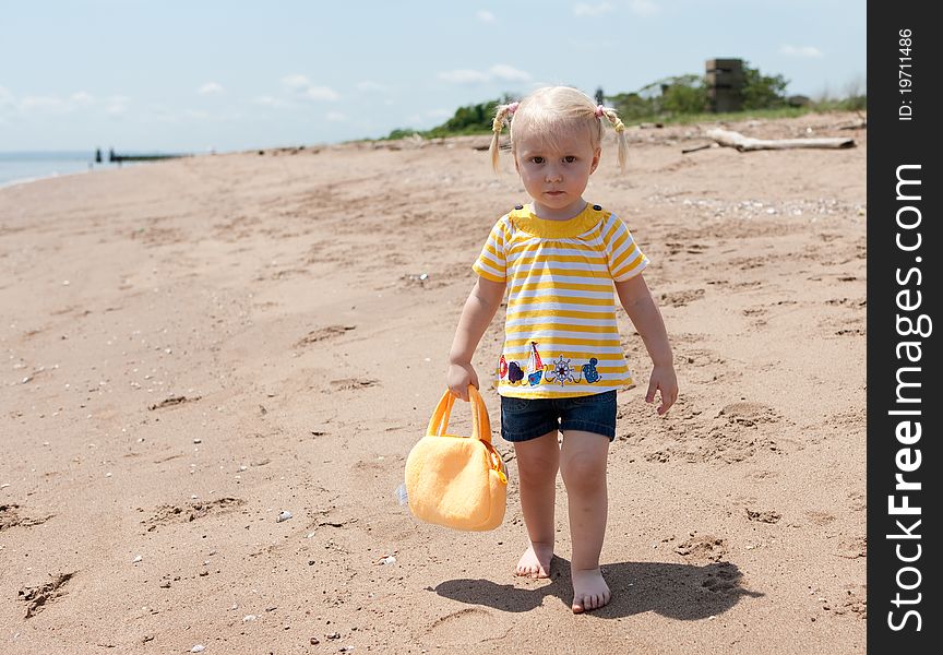 Image of the baby girl on the beach