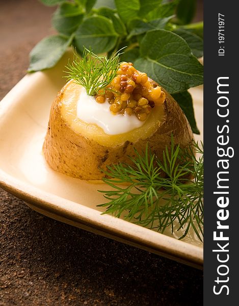 Baked potato with sour cream, grain Dijon mustard and herbs. Baked potato with sour cream, grain Dijon mustard and herbs