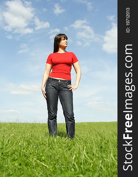 Girl standing on summer meadow