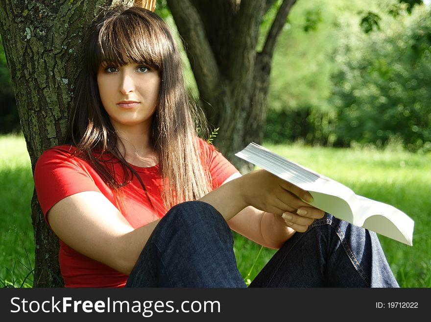 Girl Siting Near Tree And Reading Book