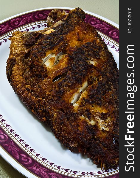 Fried fish dish cooked in oil with a food order. Fried fish dish cooked in oil with a food order.