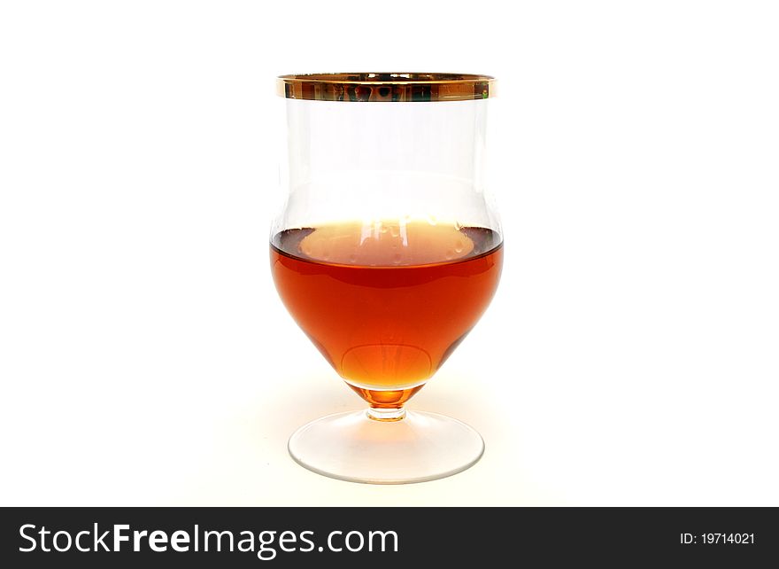 Glass With Cognac Standing On White Background