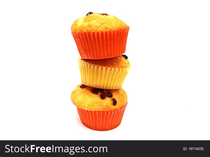 Zoomed tasty yellow three muffins on each other
