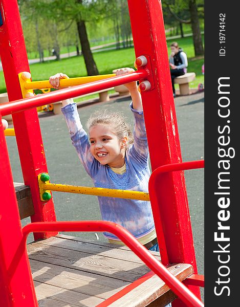 Girl having fun in playground in a park