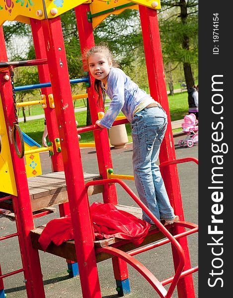 Girl having fun in playground in a park