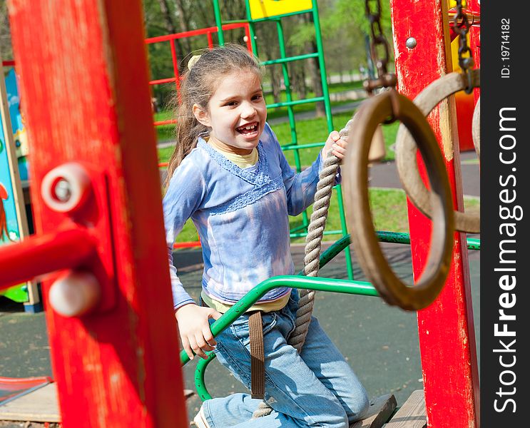 Girl Having Fun In Playground