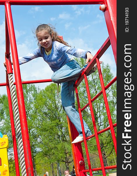 Girl having fun in playground in a park