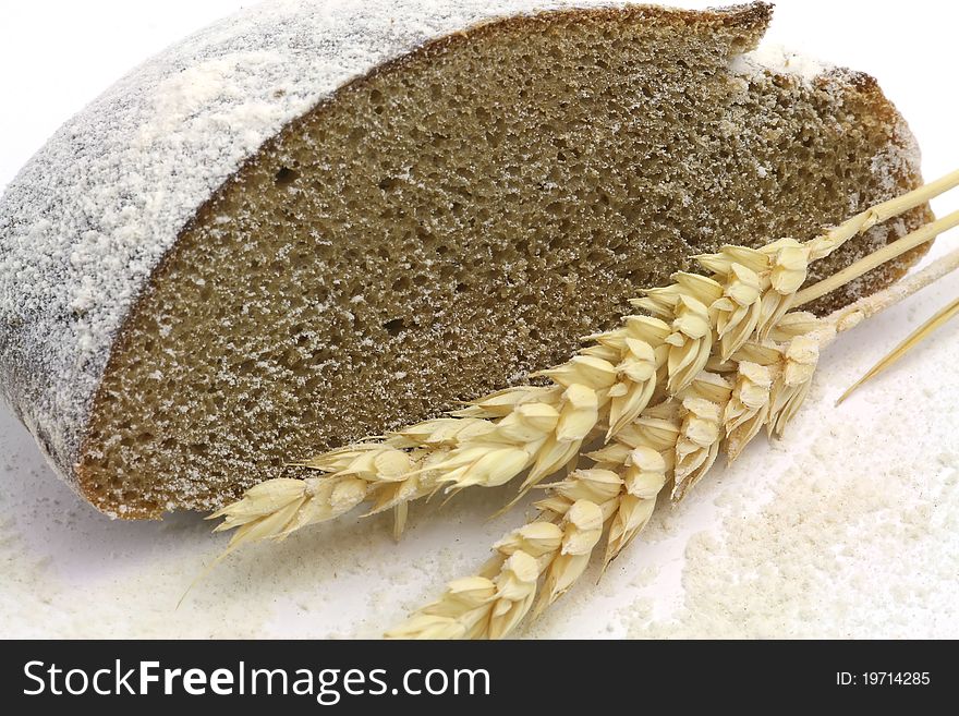 Rye bread and spikes of rye and flour over white