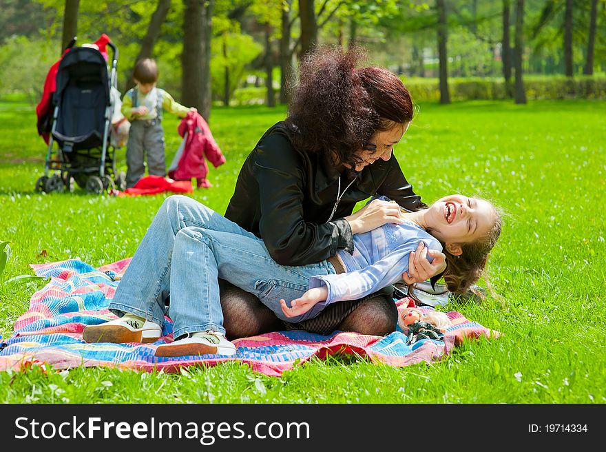 Mother with children resting and playing in the park