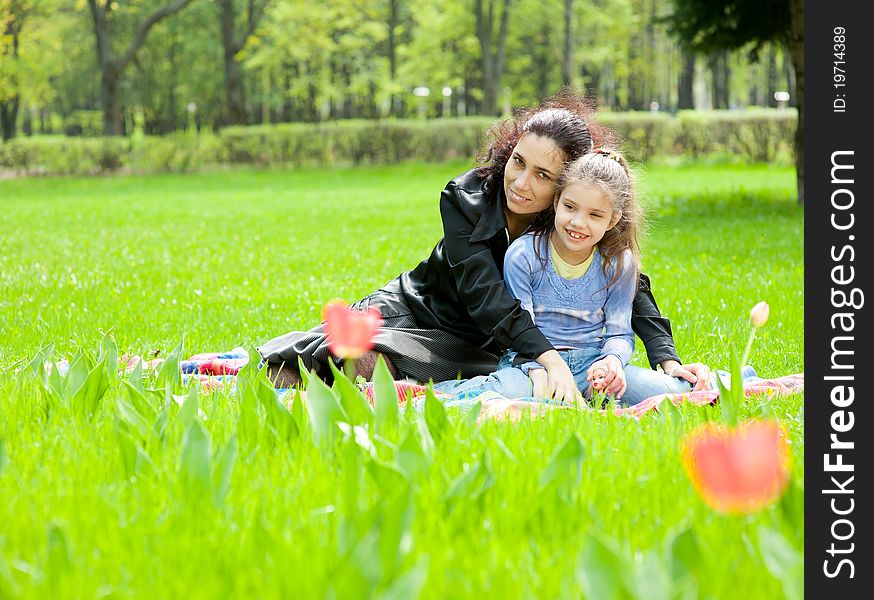 Mother with daughter resting in the park