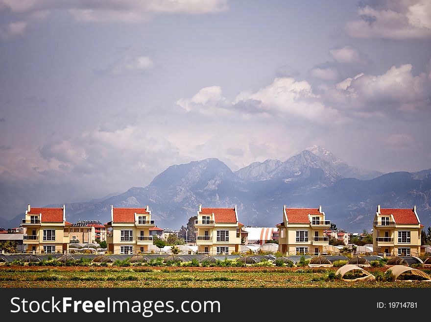 Modern houses in a row, mountains on background