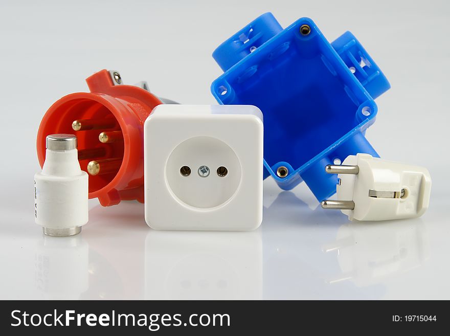 Some material which is needed for the installation of power wiring in houses like a fuse, outlet, plug. Some material which is needed for the installation of power wiring in houses like a fuse, outlet, plug