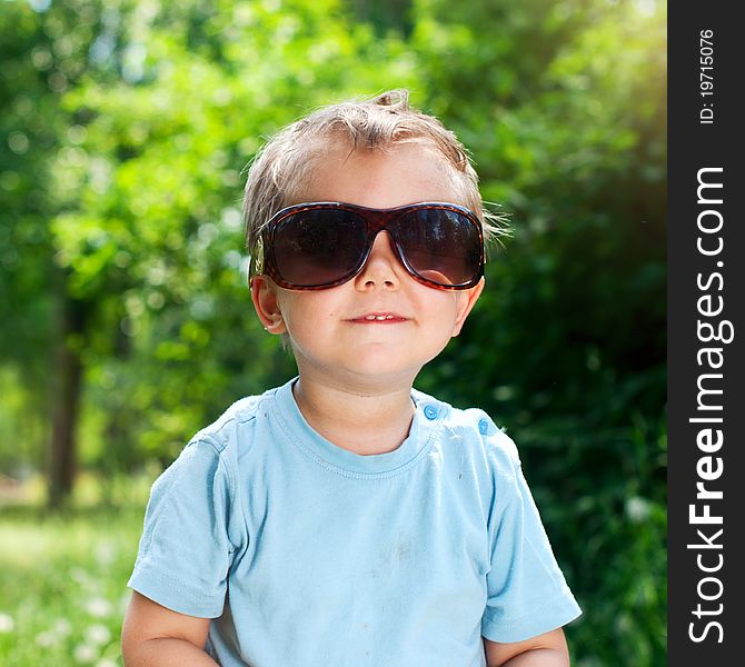 Cute 2 years old boy Sunglasses outdoors at sunny summer day. Cute 2 years old boy Sunglasses outdoors at sunny summer day