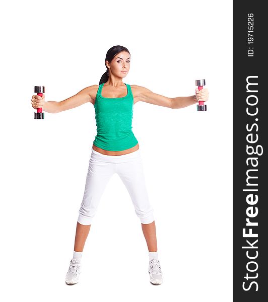 Beautiful young  woman with dumbbells, against white background