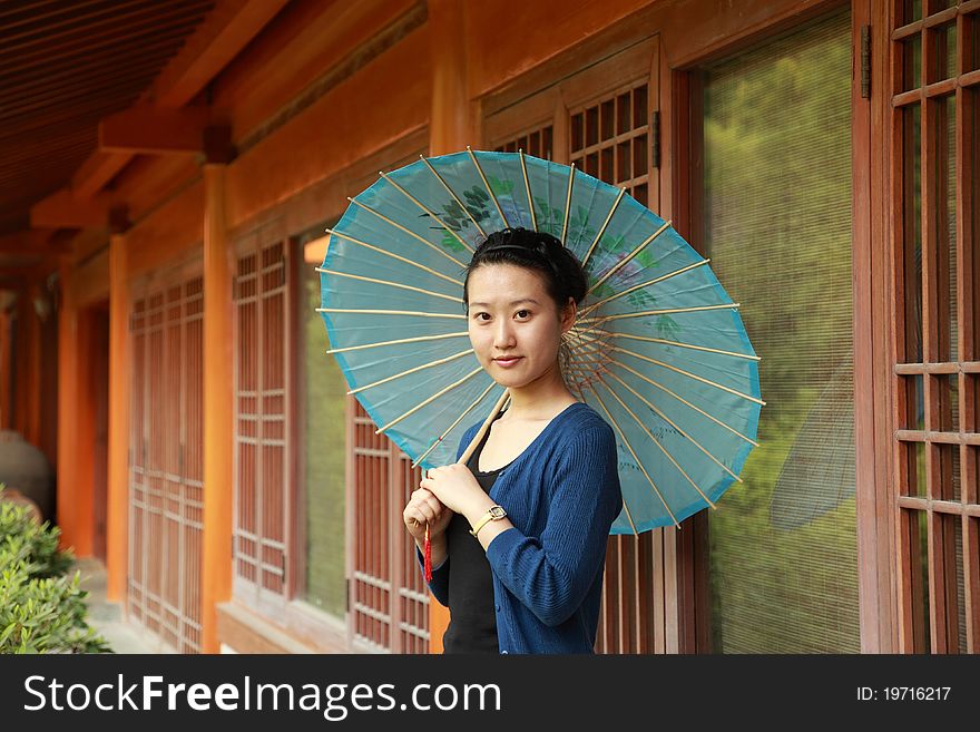 Attractive young woman with an umbrella. Attractive young woman with an umbrella