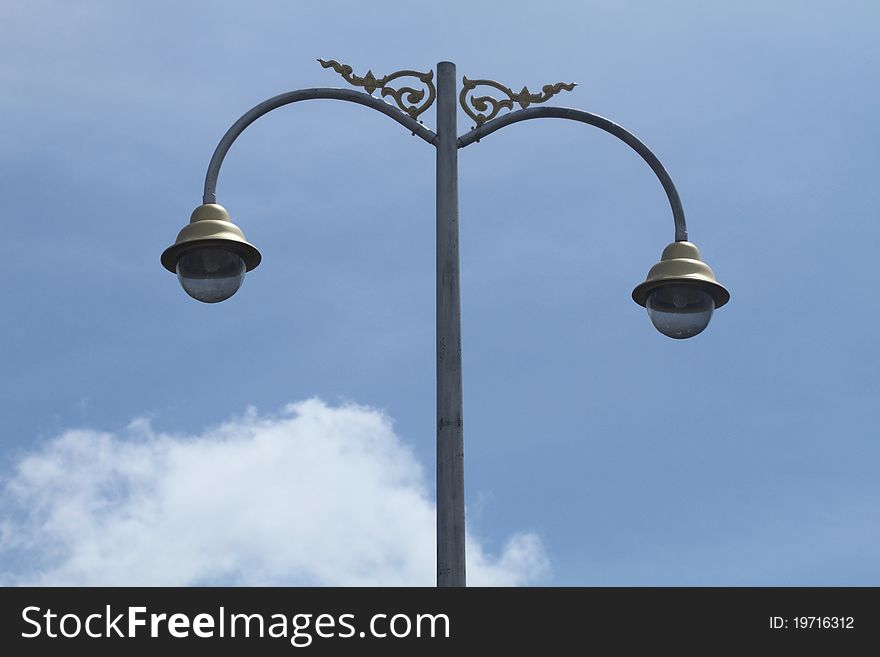 Big streetlamp against  blue  sky. Big streetlamp against  blue  sky