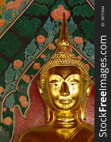 Gold Face of Lord Buddha, Thai background and flower pattern painting of Thailand.