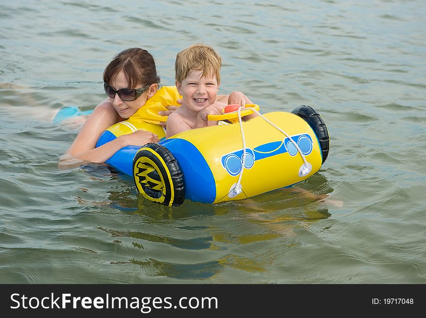 Happy Family In The Waves On The Sea