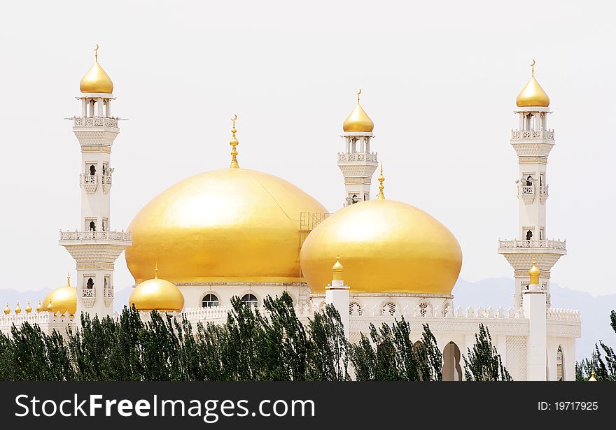 Domes and towers of a golden mosque