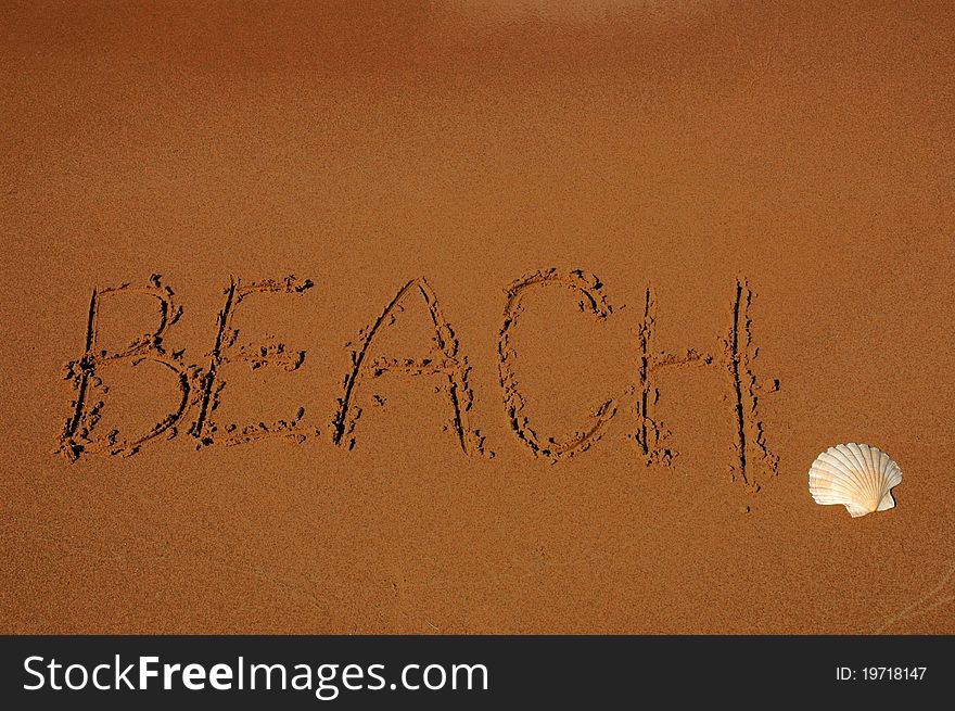 The word beach on sand