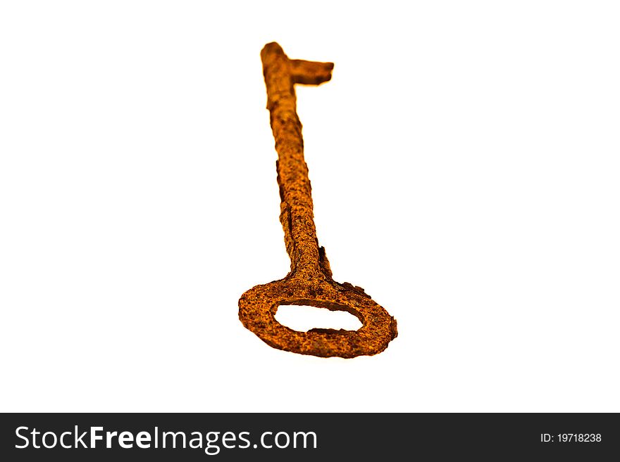 An old rusty key on a white background