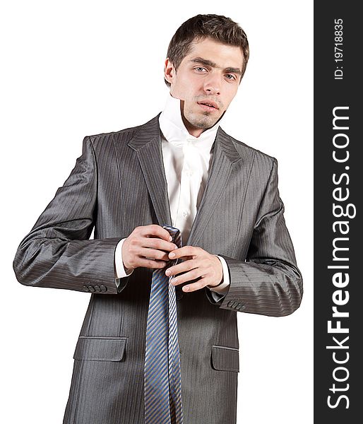 Portrait of a young dressing elegant man in classical suit on isolated white background
