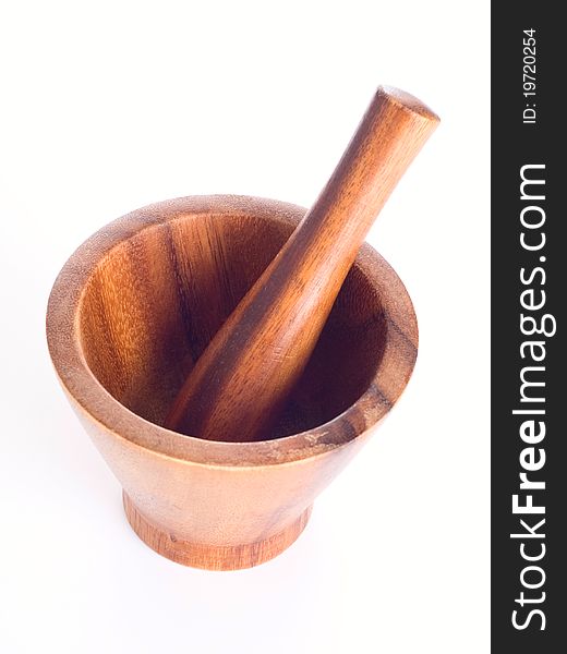 Wooden pounder and pestle on white