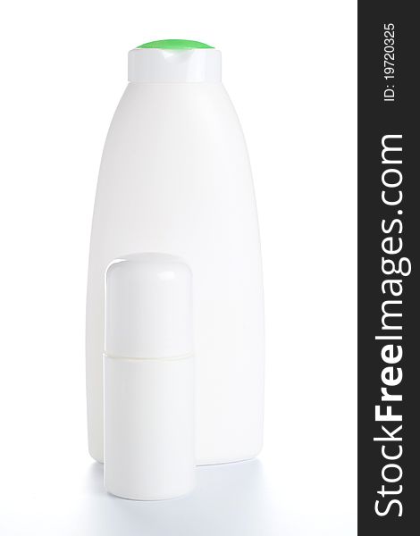 Deodorant and White shampoo bottle with green cap