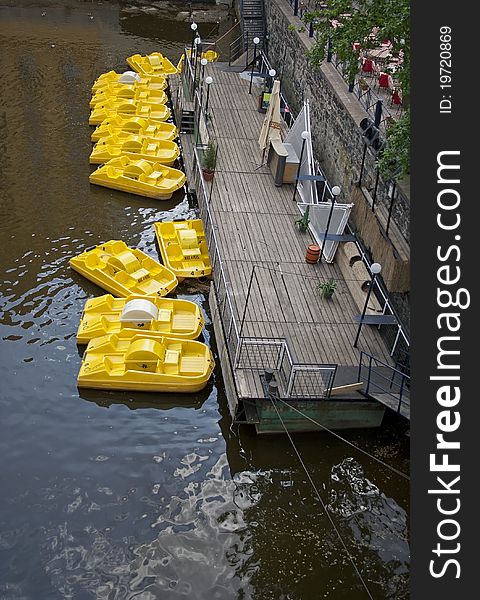 Yellow boats anchored at a pontoon in Prague