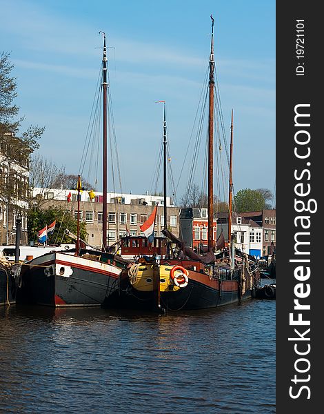 Old transportation ships in a canal of Gouda, Netherlands. Old transportation ships in a canal of Gouda, Netherlands