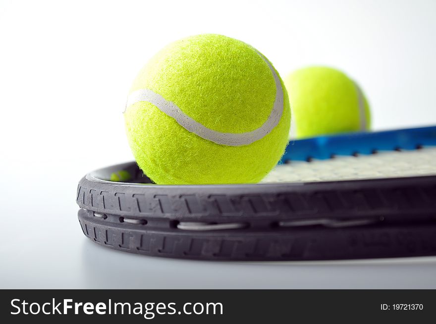 Two tennis balls on racket with isolated white background.