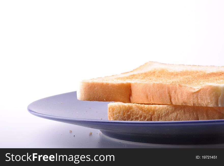 Two pieces of toast are on blue dish isolated on white background.