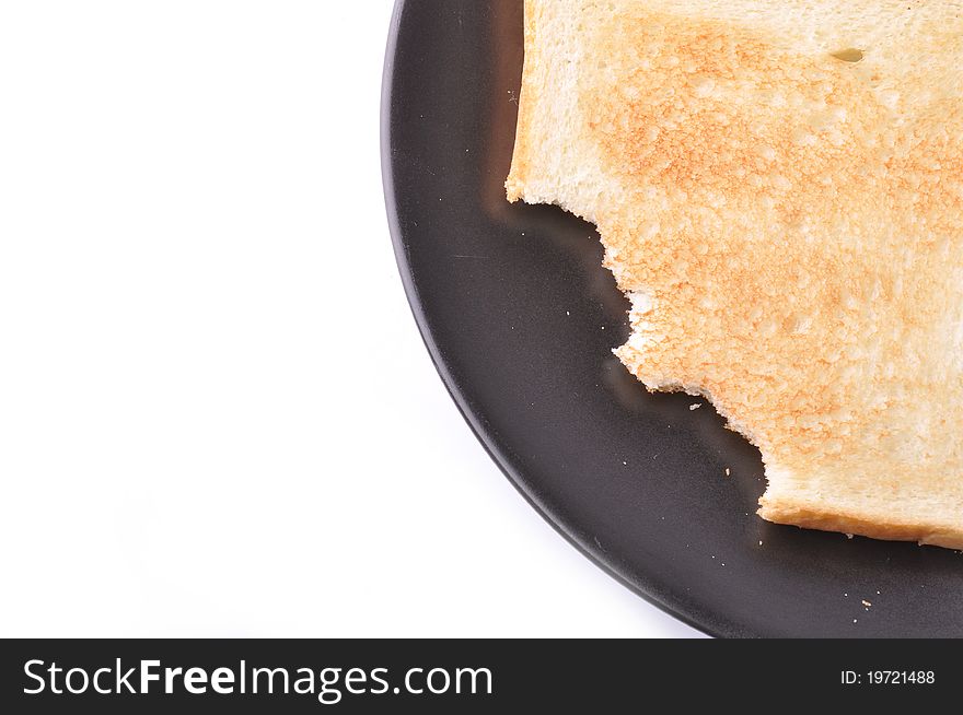 A pieces of toast are on black dish isolated on white background.