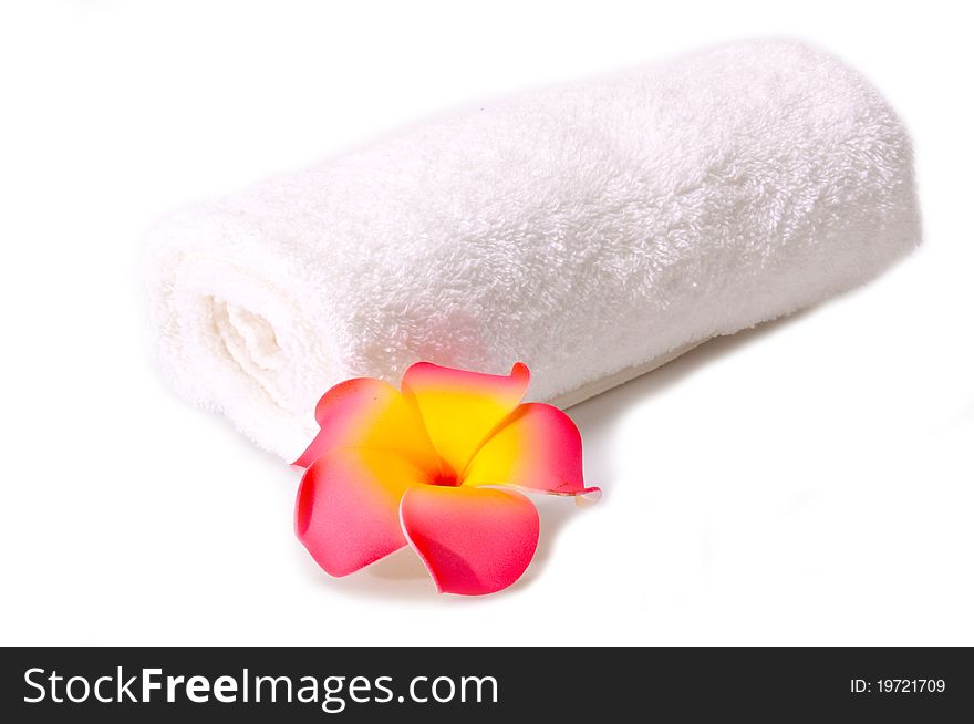 A plumeria and a white towel isolated on the white background.