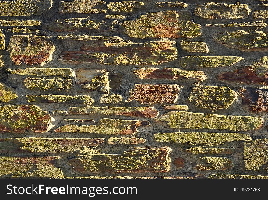 Background texture of sunset lit stone wall