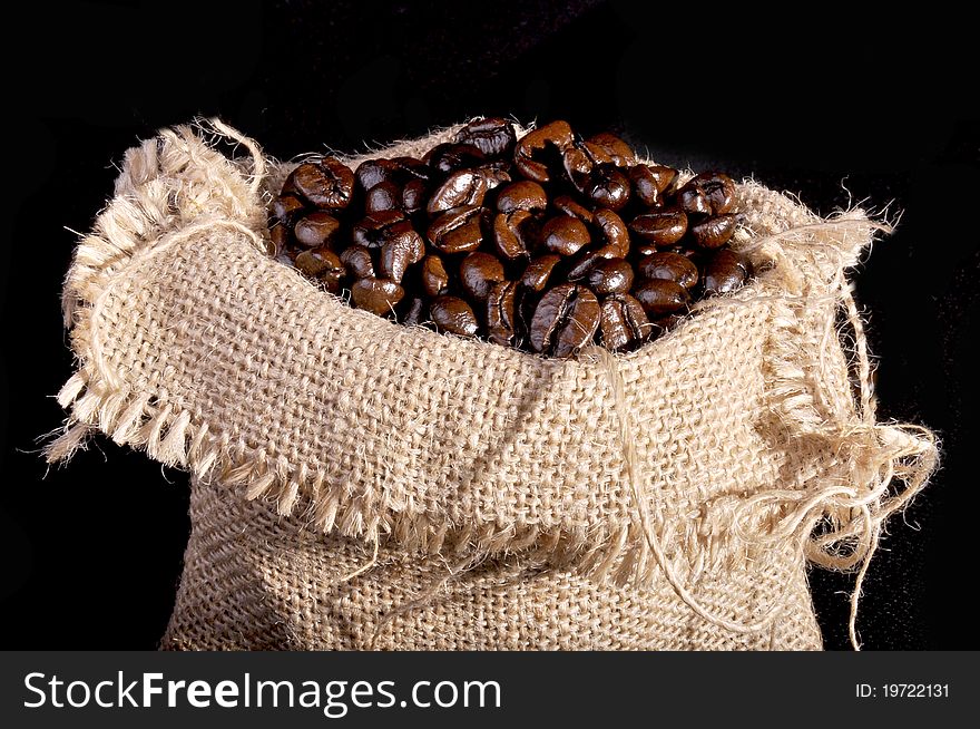 A lot of coffee beans inside the canvas sack.