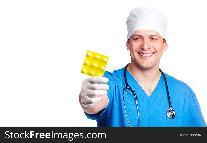 Portrait of doctor wearing a blue uniform and giving us pills. isolated on white background. Portrait of doctor wearing a blue uniform and giving us pills. isolated on white background