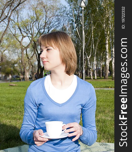 Girl drinking tea in the park. Girl drinking tea in the park