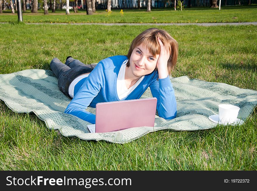 Beautiful girl working on laptop in the park. Beautiful girl working on laptop in the park