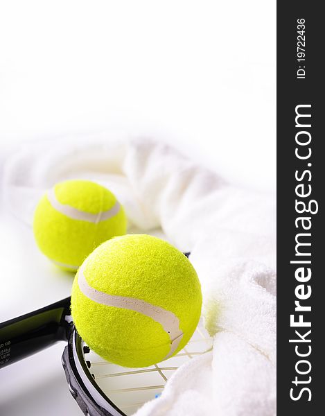 Two tennis balls and white towel on the racket isolated on white background.