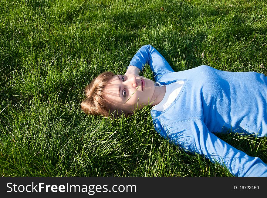 Beautiful girl lying on the green grass. Beautiful girl lying on the green grass