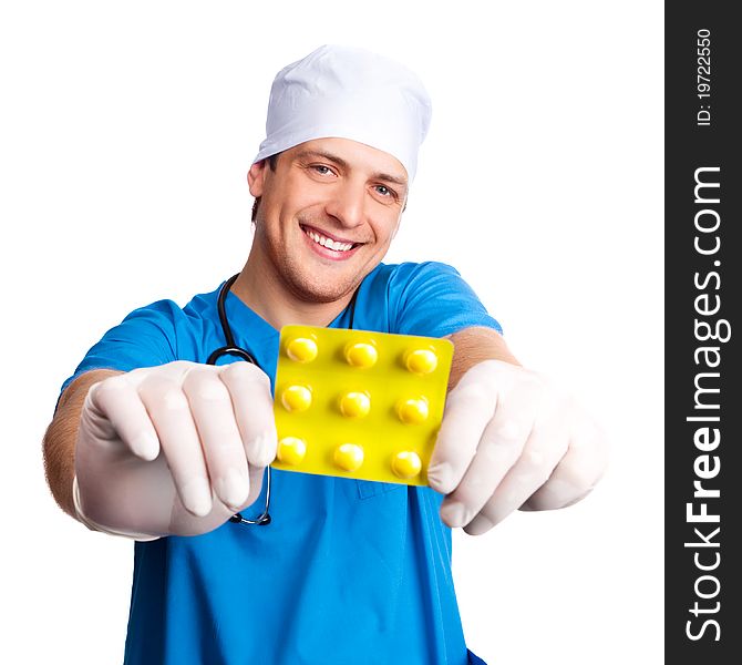 Portrait of doctor wearing a blue uniform and giving us pills. isolated on white background. Portrait of doctor wearing a blue uniform and giving us pills. isolated on white background