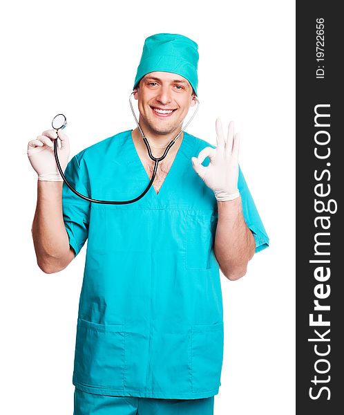 Portrait of a surgeon holding a stethoscope and showing the sigh OK, isolated against white background